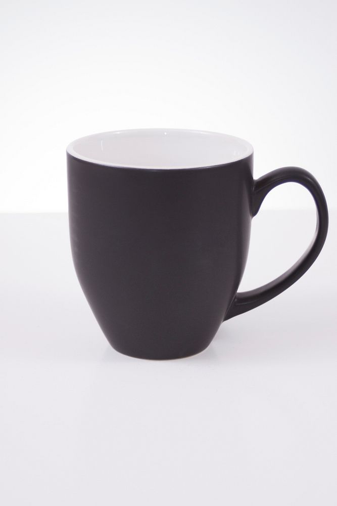 Black coffee mug on white table. Free public domain CC0 image