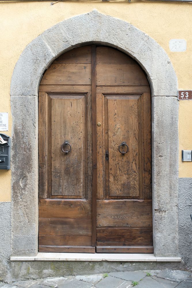 Arched wooden door, architecture. Free public domain CC0 photo.