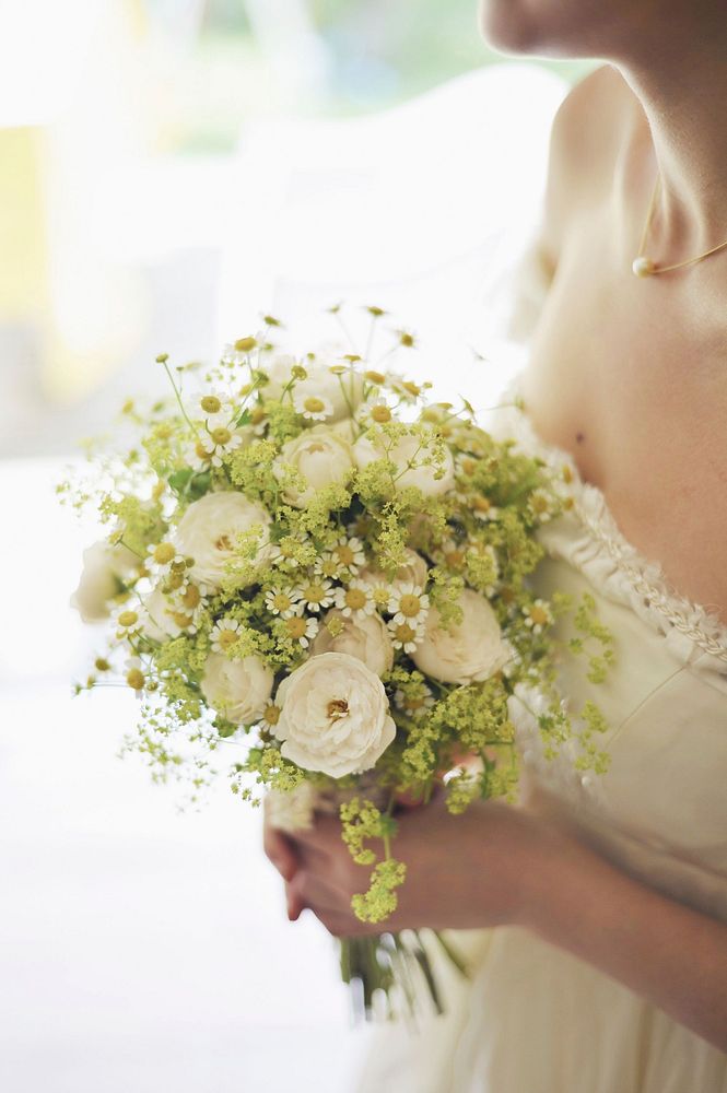 Free bride holding flower bouquet image, public domain CC0 photo.