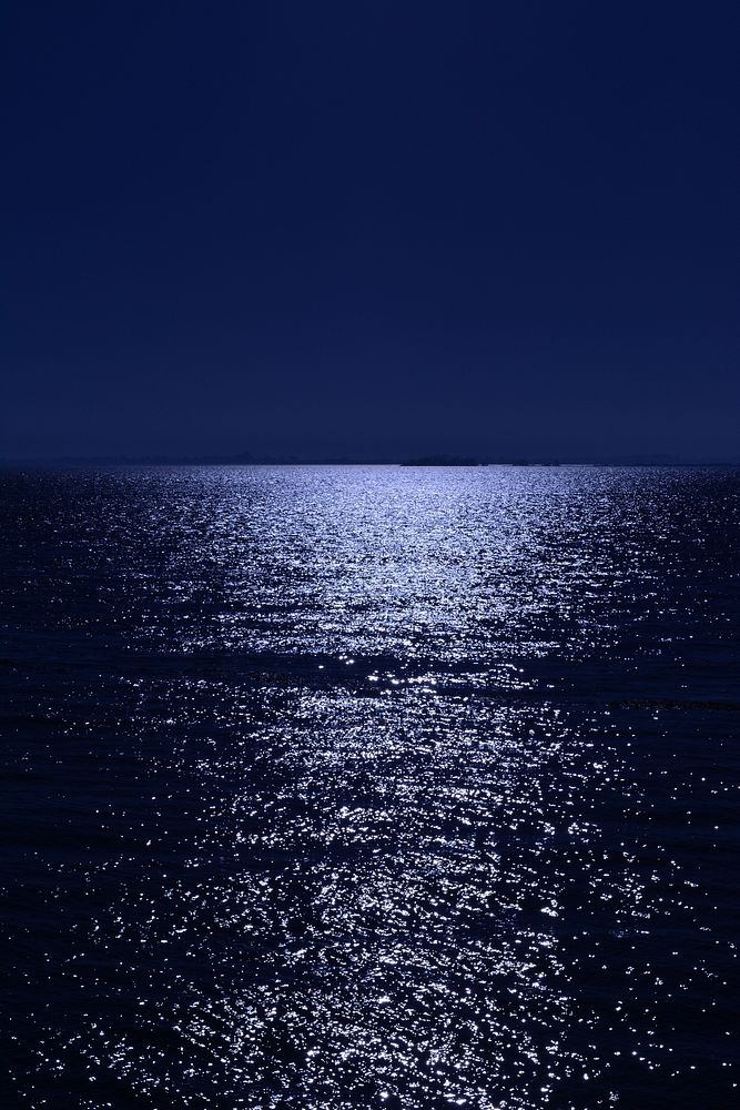 Night light shinning on water. Free public domain CC0 image.