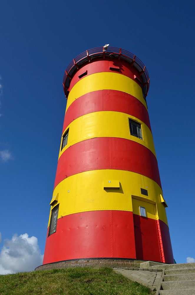 Closeup on a red and yellow lighthouse. Free public domain CC0 photo.