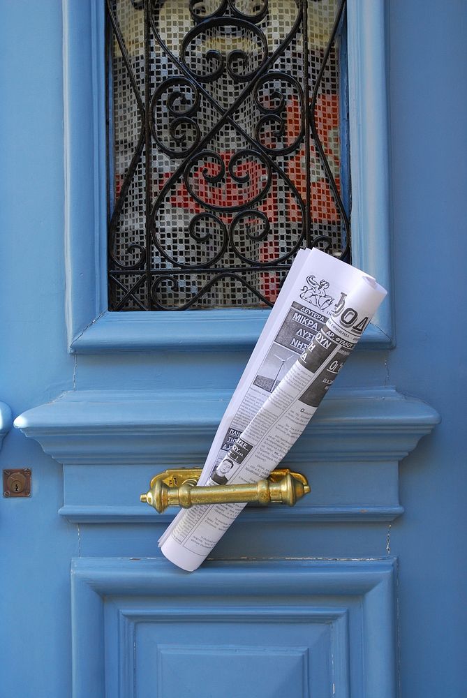 Newspaper on door. Free public domain CC0 photo.