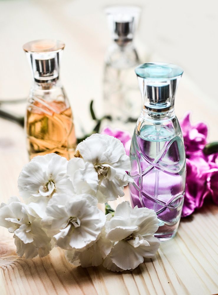 Perfume bottles and white flower. Free public domain CC0 photo.