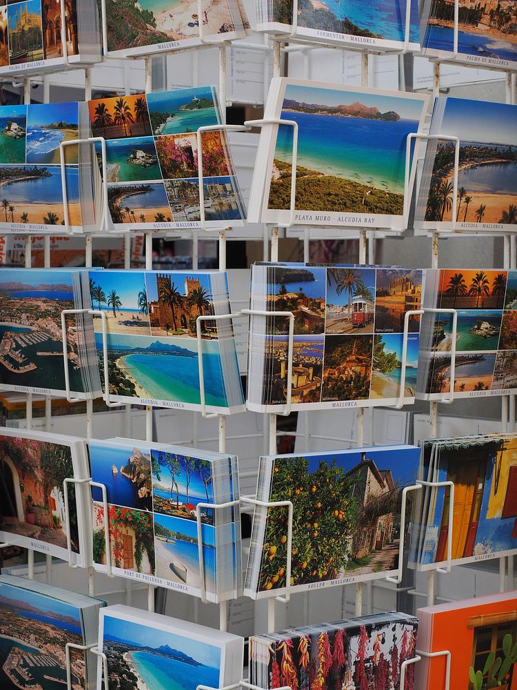 Travel postcards on racks. Free public domain CC0 photo.