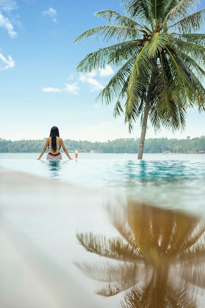 Free woman sitting on swimming pool photo, public domain travel CC0 image.