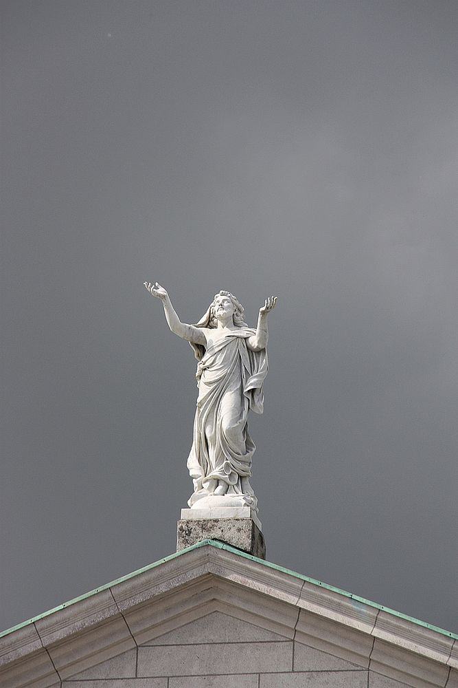 Statue on historical church roof. Free public domain CC0 image.