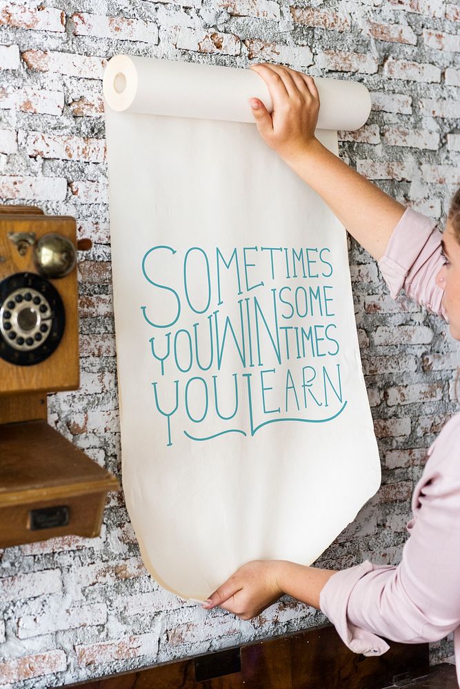 A woman holding a poster with motivation quote