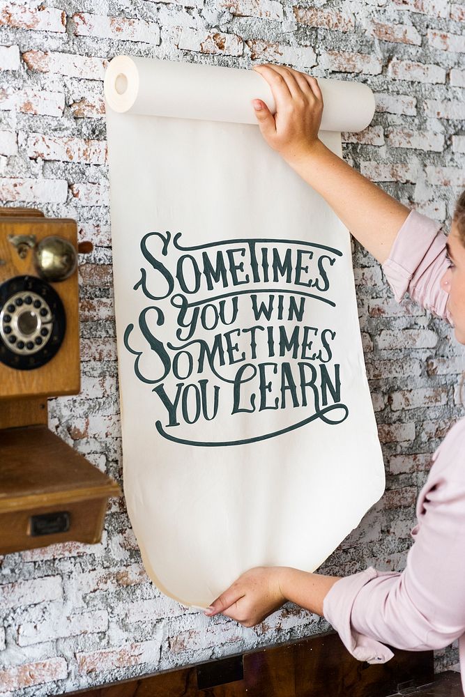 A woman holding a poster with motivation quote