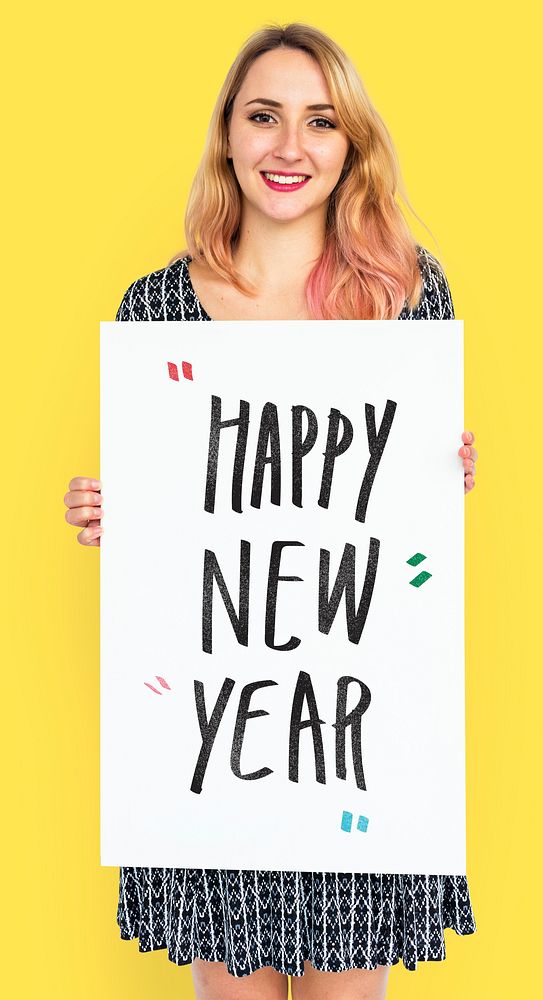 Cheerful woman holding a happy new year poster