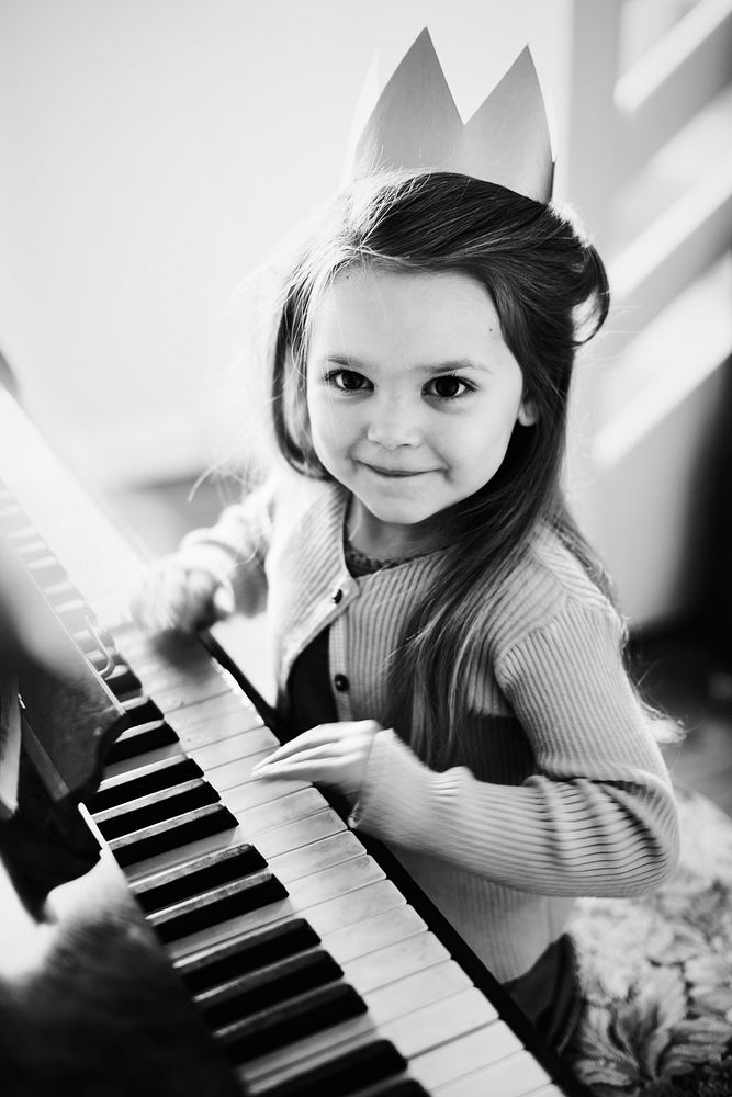 Little Caucasian girl playing piano