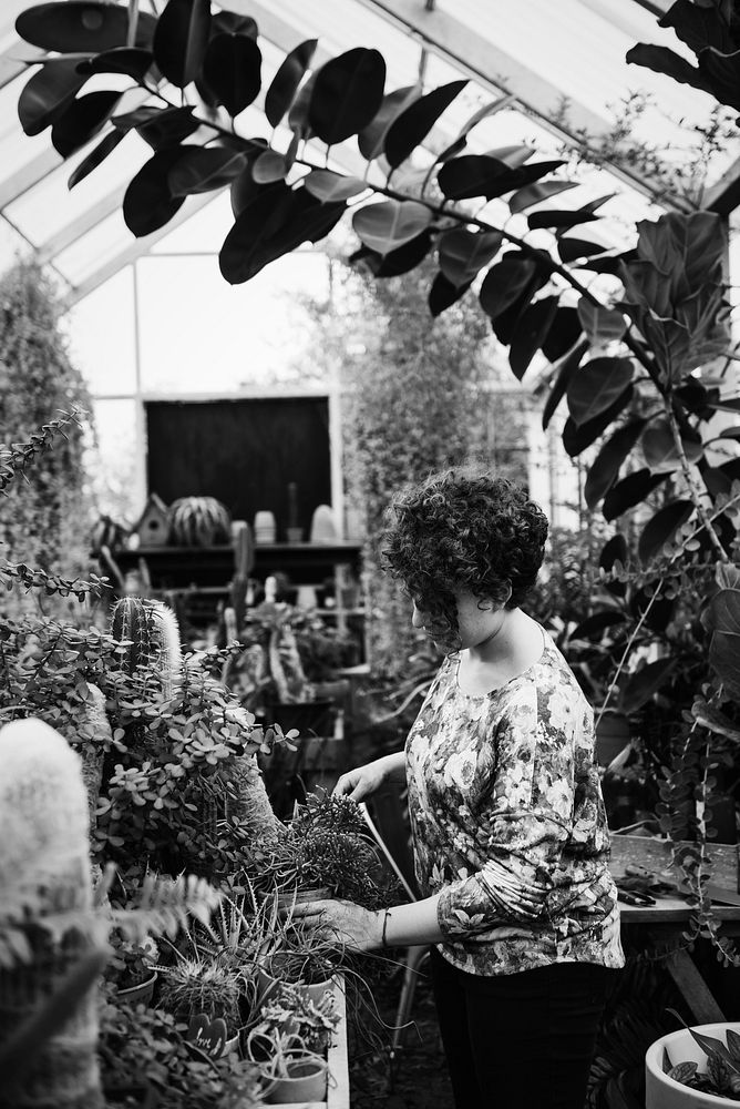 Woman arranging flowers in a greenhouse