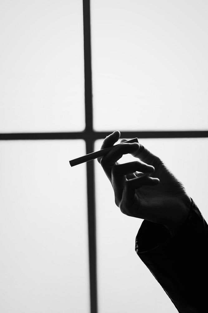 Greyscale style of cigarette in a hand
