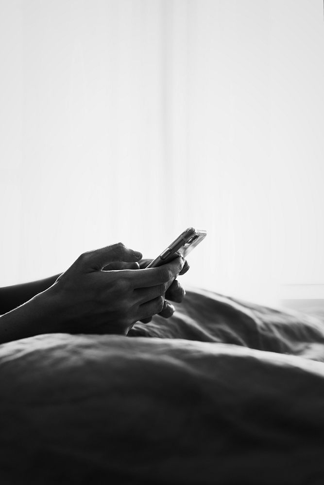 Woman using a phone in bed