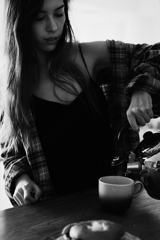 Young woman pouring a coffee