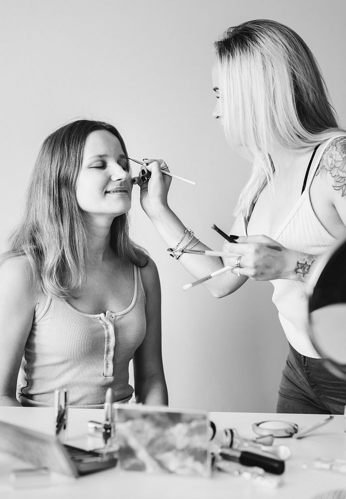 Artist applying makeup on a client