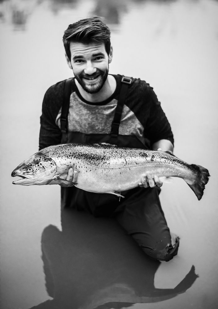 Man caught salmon fish in a river