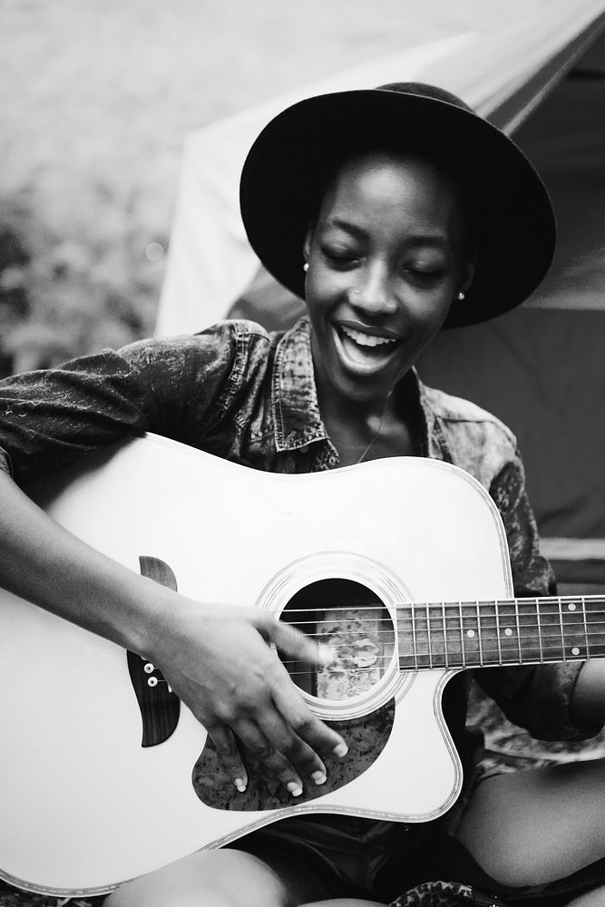 Woman playing a song on a guitar
