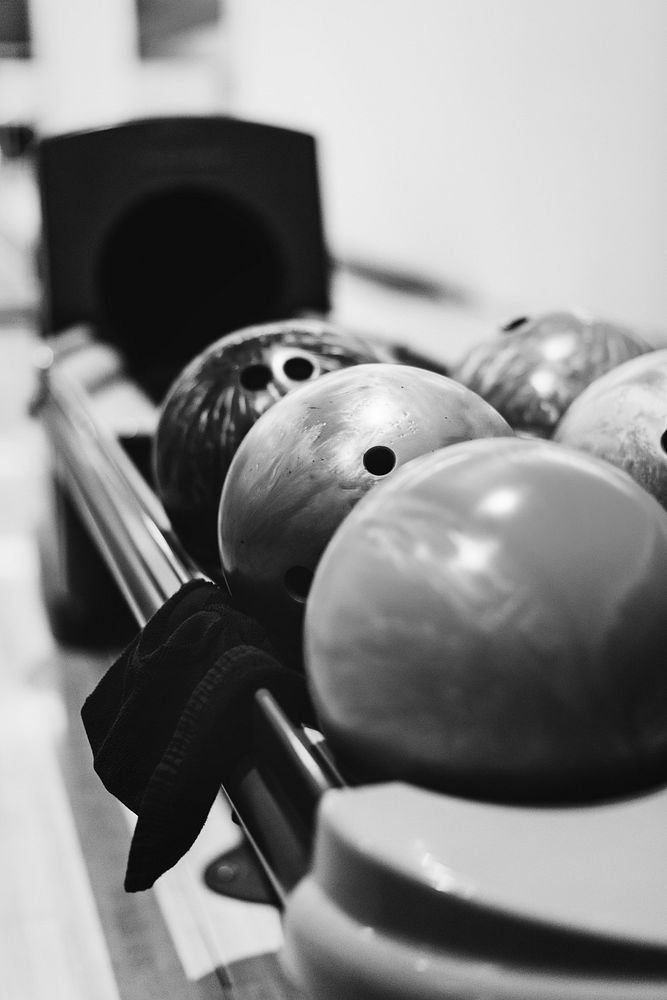 Bowling balls lined at the bowling alley