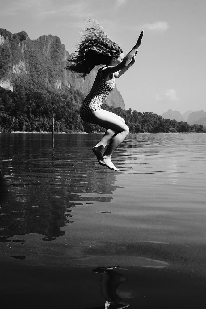 Woman jumping into the water
