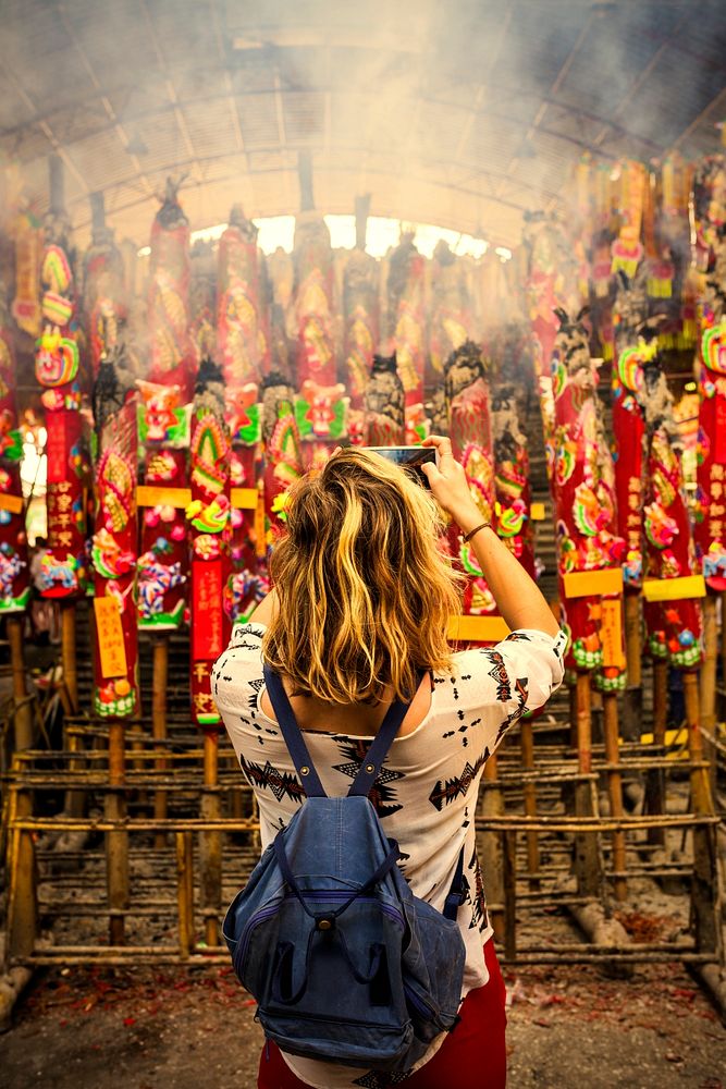 Tourist taking photos at a Chinese temple