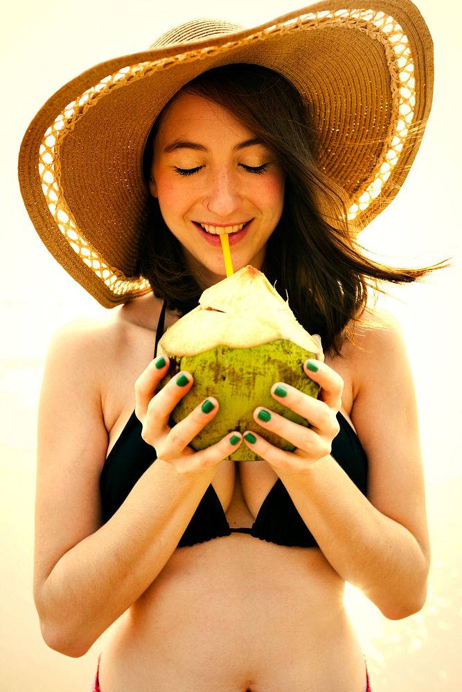 Beautiful girl drinking a fresh coconut