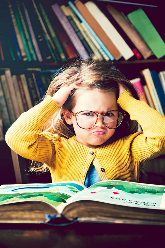 Little girl immersed in books