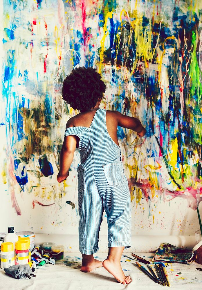 African kid painting on wall