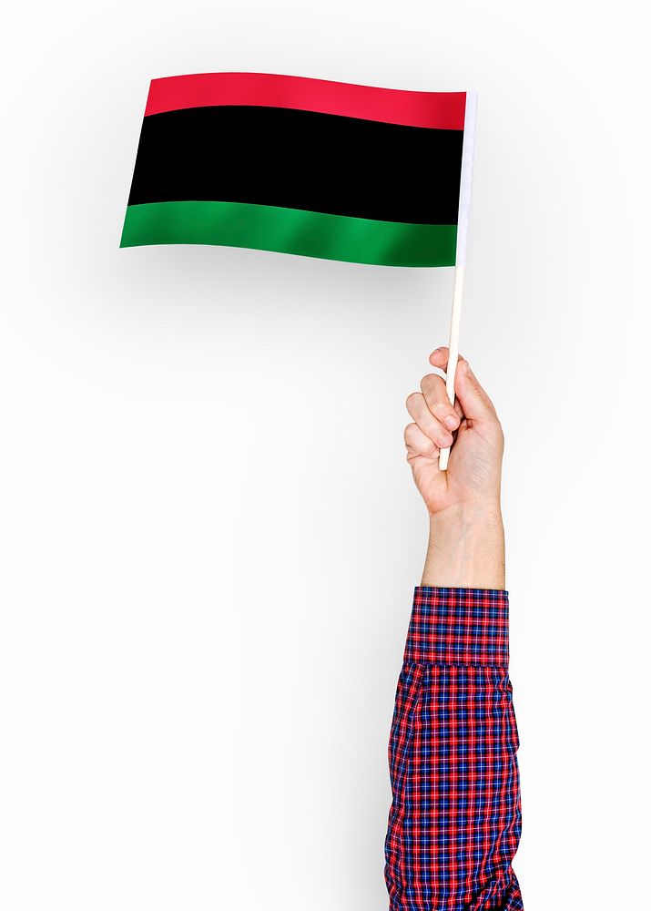 Person waving the flag of Pan-African flag