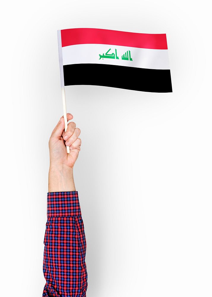 Person waving the flag of Republic of Iraq