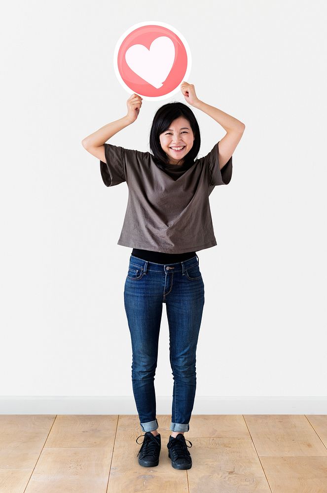 Japanese woman holding up a heart