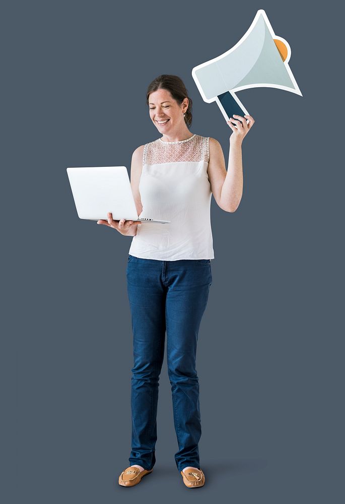 Woman holding a megaphone and using a laptop