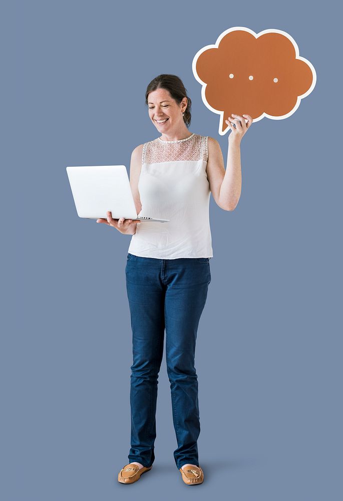Woman holding a speech bubble and using a laptop