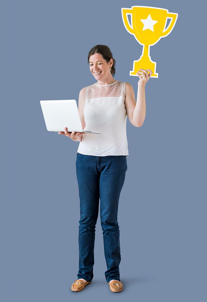 Woman holding a trophy icon and using a laptop