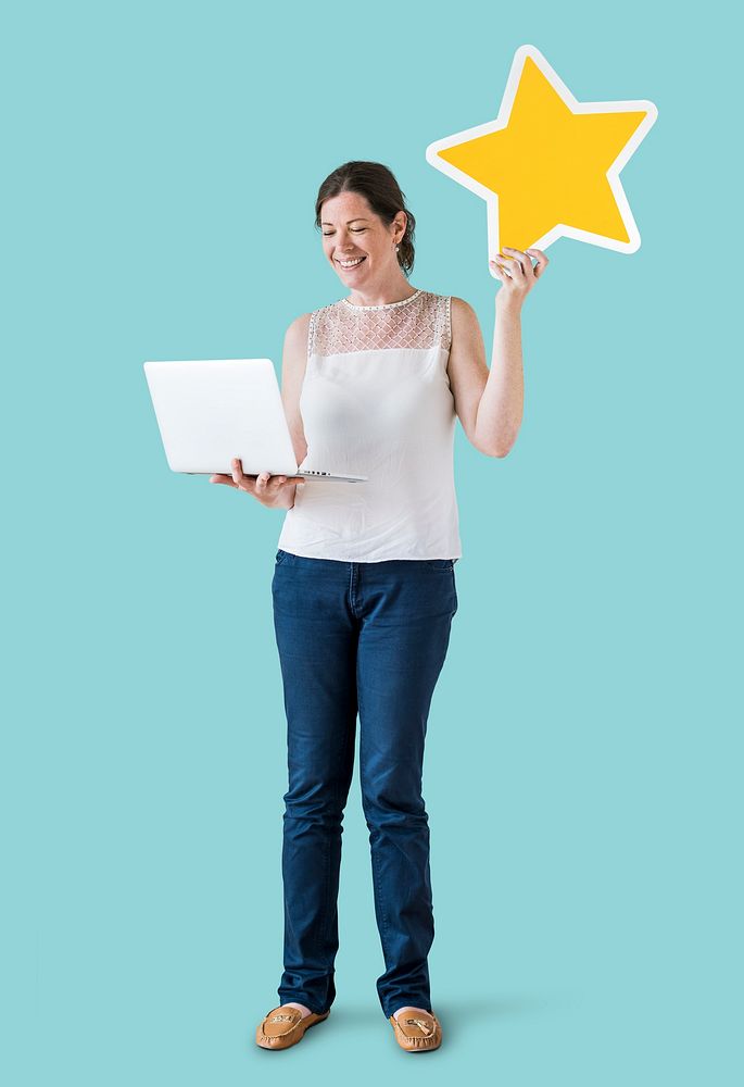 Woman holding a star icon and using a laptop
