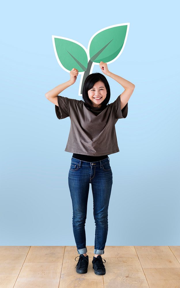 Cheerful woman holding a plant icon