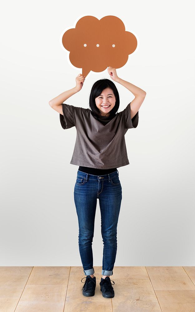 Cheerful woman holding a brown speech bubble icon