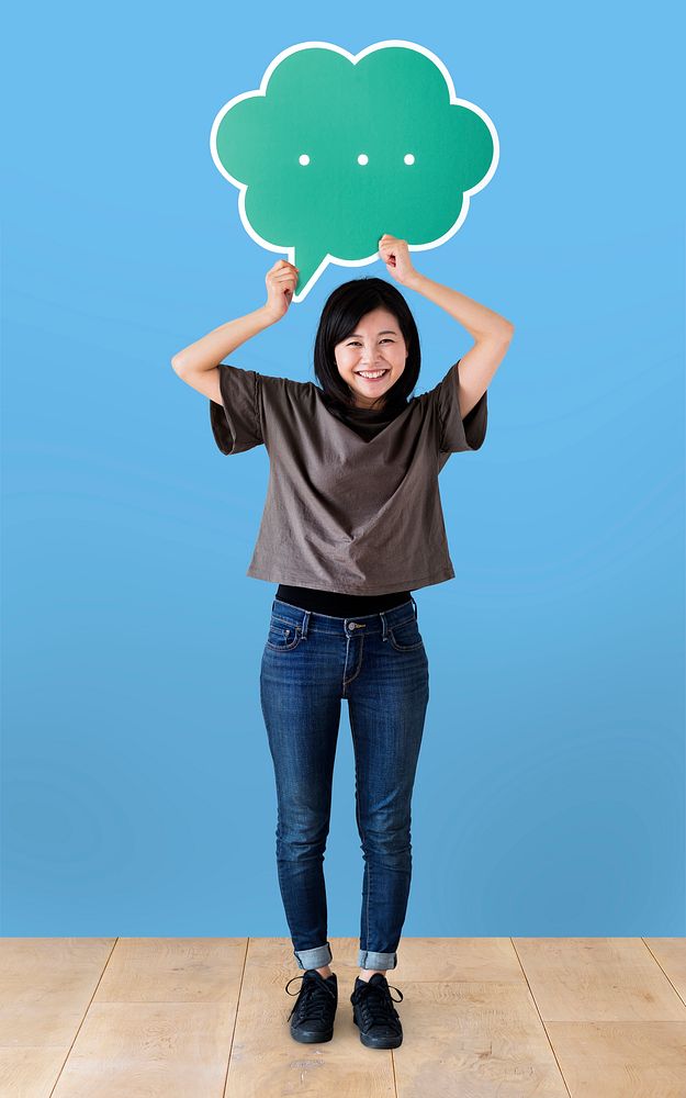 Cheerful woman holding a green speech bubble