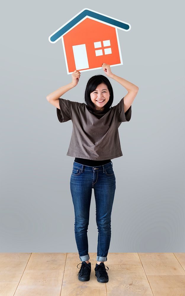 Cheerful woman holding a house icon