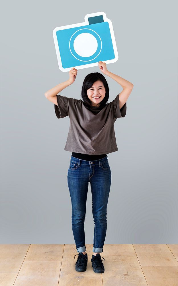 Cheerful woman holding a camera icon