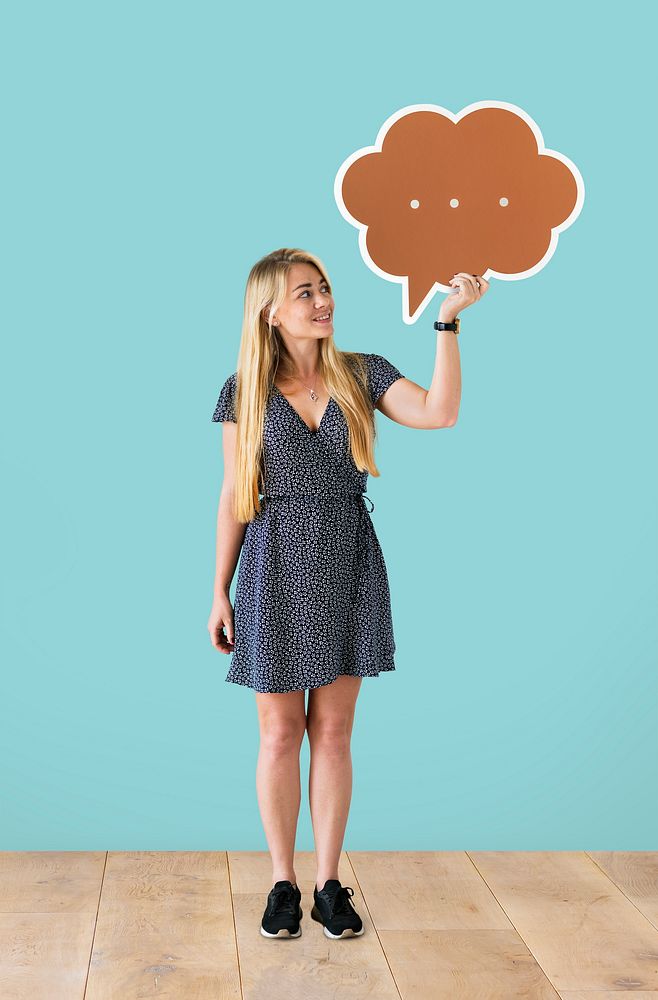 Cheerful woman holding a brown speech bubble