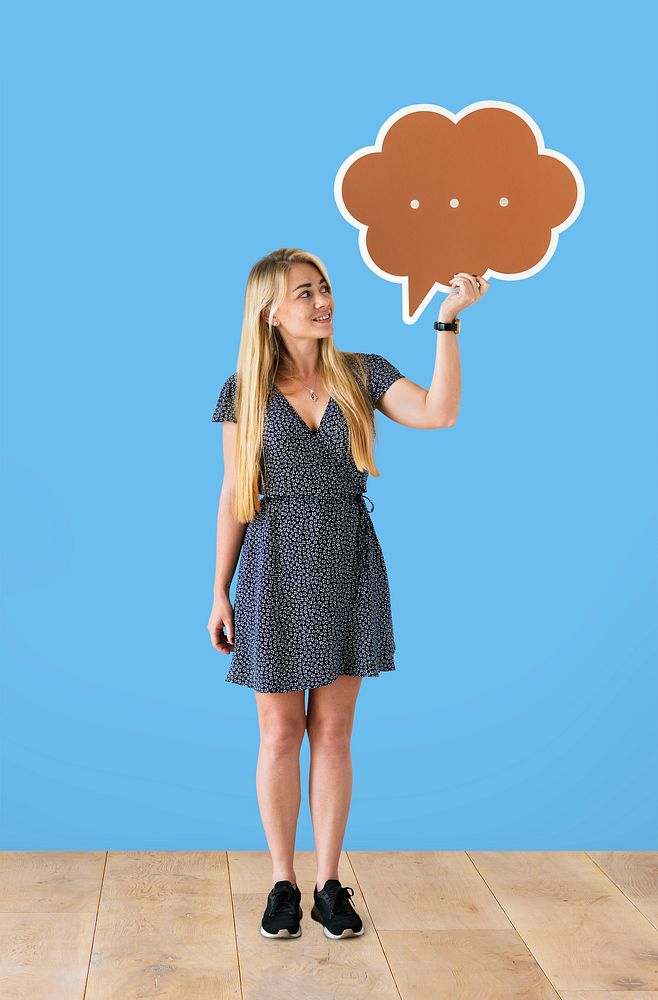 Cheerful woman holding a brown speech bubble