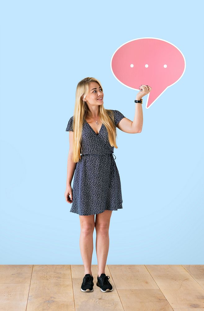 Cheerful woman holding a pink speech bubble
