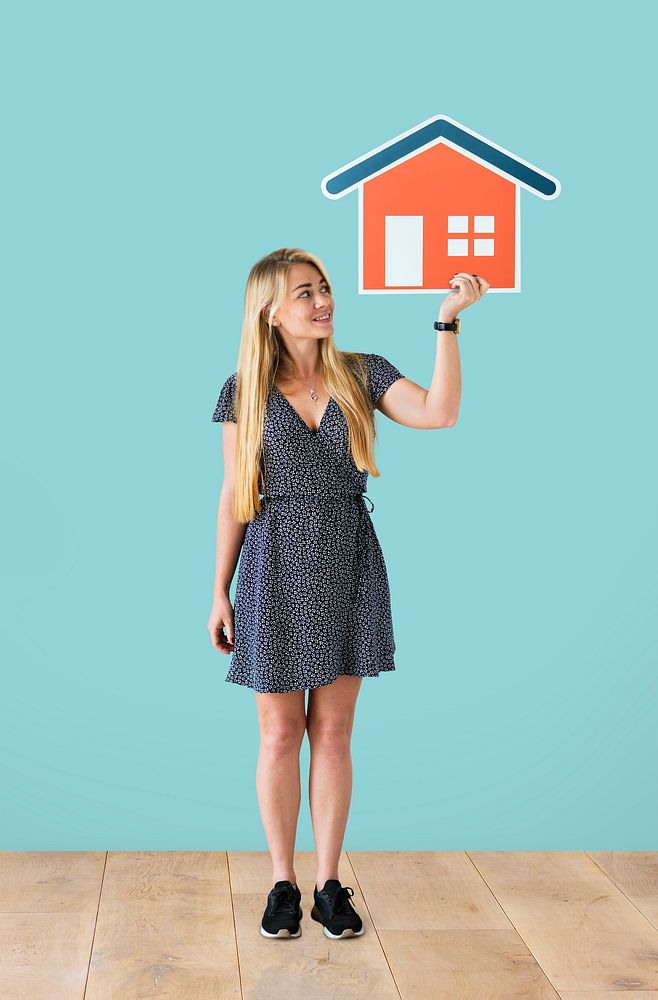 Cheerful woman holding a house icon