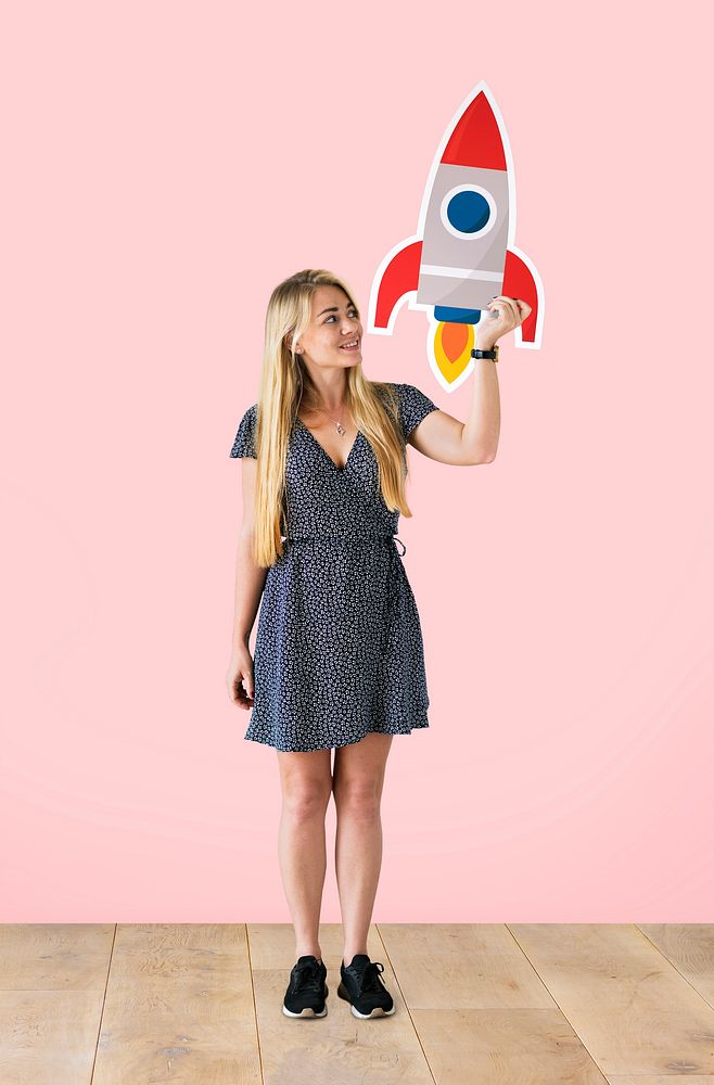 Cheerful woman holding a rocket