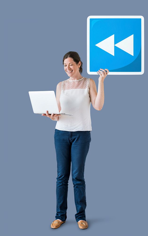 Woman holding a rewind button and a laptop