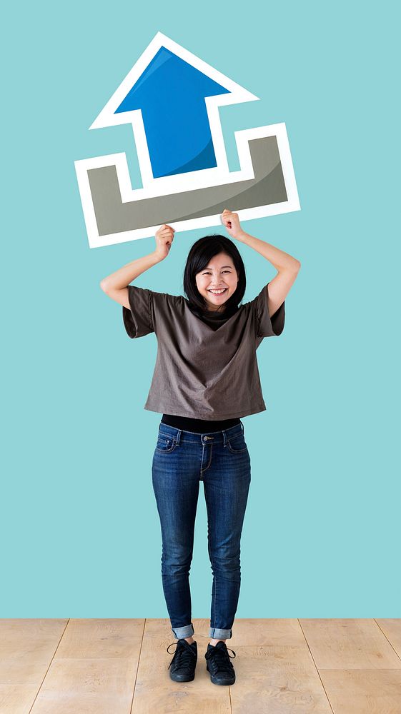 Woman holding an upload icon in a studio