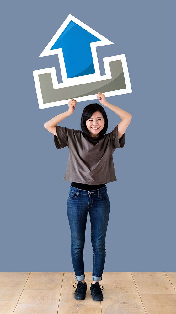 Woman holding an upload icon in a studio