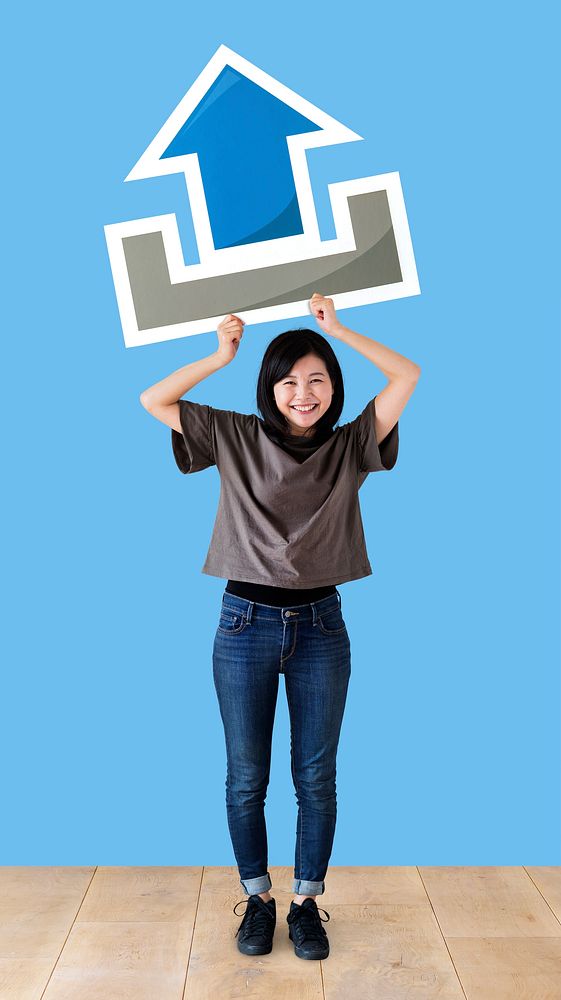 Woman holding an upload icon in a studio