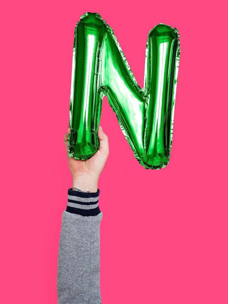 Hand holding balloon letter N