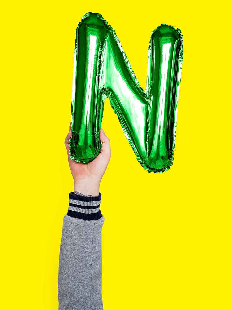Hand holding balloon letter N